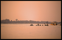 During sunset, kids play in the Mekong River. Si Phan Don, Don Khong, Laos